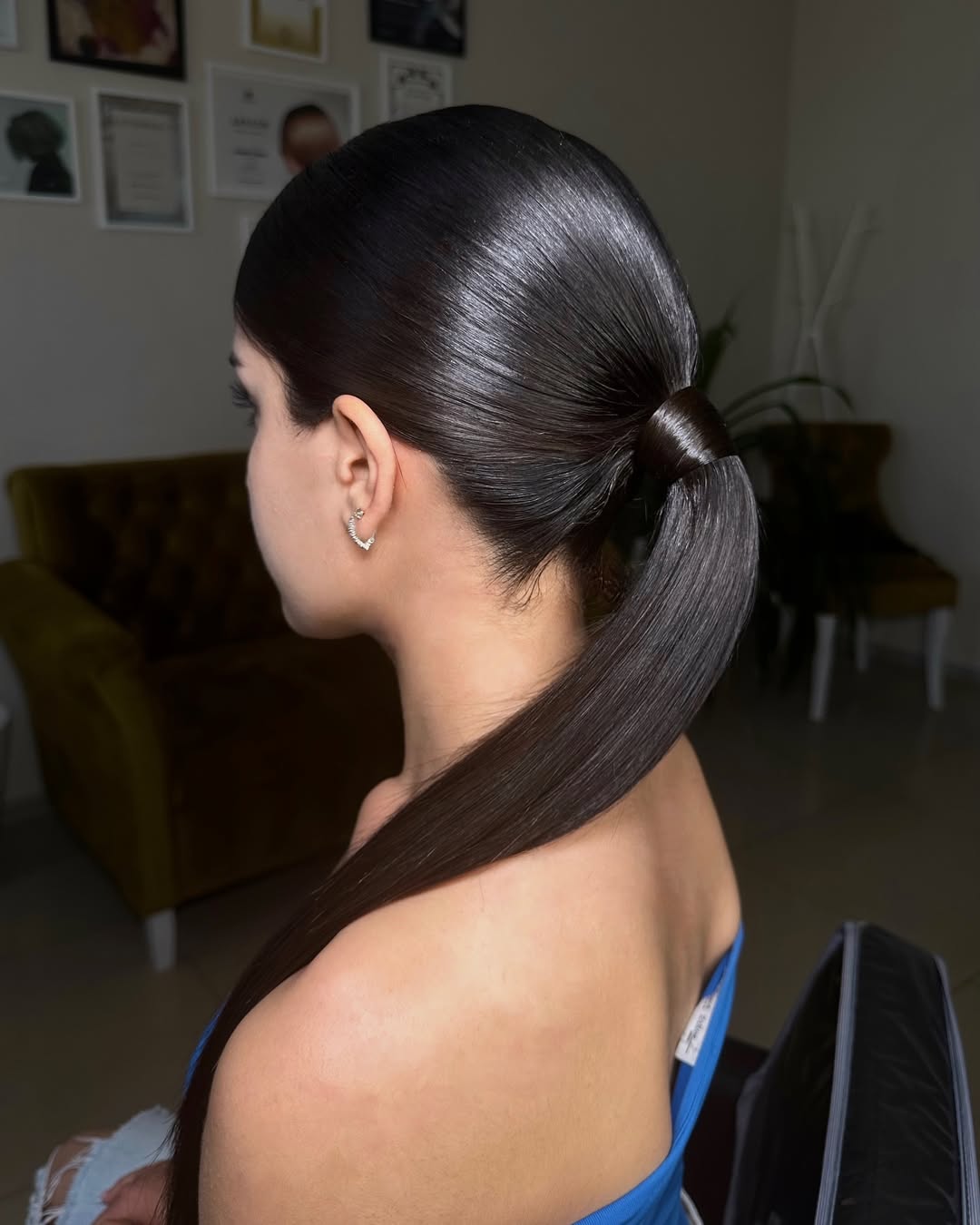 Woman with loose waves and a center part, showcasing an elegant and effortless summer hairstyle perfect for everyday wear or a casual brunch.