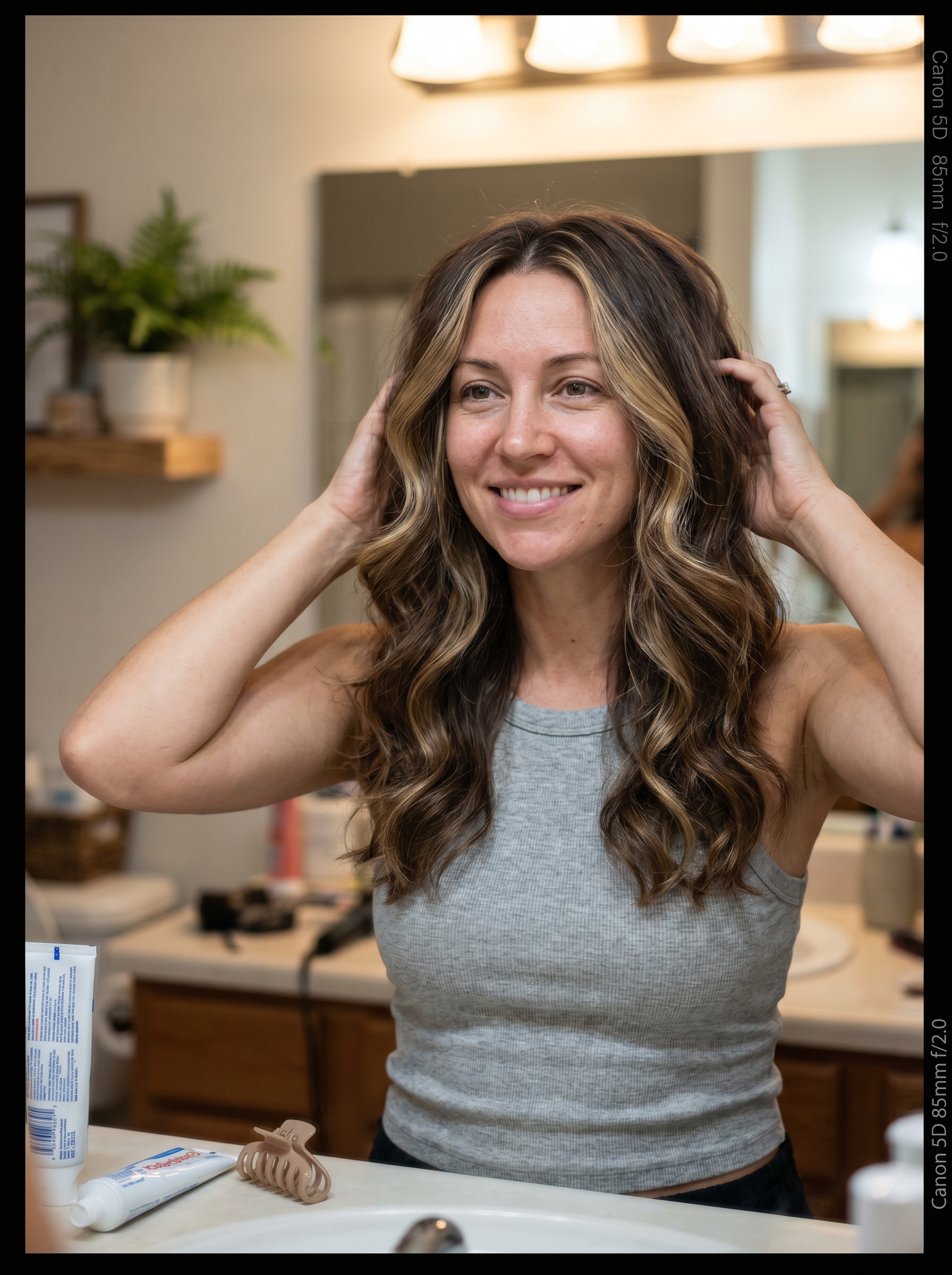 Glamorous Nectar Blonde Curve Cut with face-framing balayage, a voluminous flattering summer haircut 2026, styled with a large round brush and hairspray.