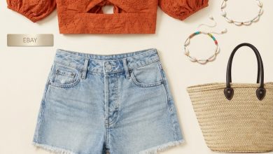 Relaxed late summer outfit for a farmers market, with a terracotta embroidered crop top, light wash denim shorts, slide sandals, a market bag, and a beaded anklet.