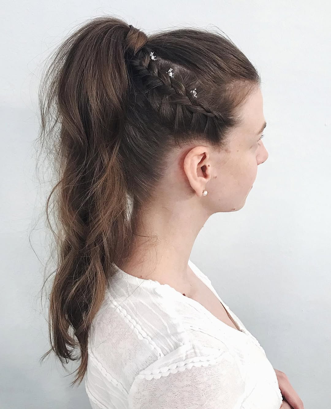 Beautiful blonde woman with a soft, romantic updo, featuring loose tendrils framing her face, perfect outdoor wedding hair summer 2026.