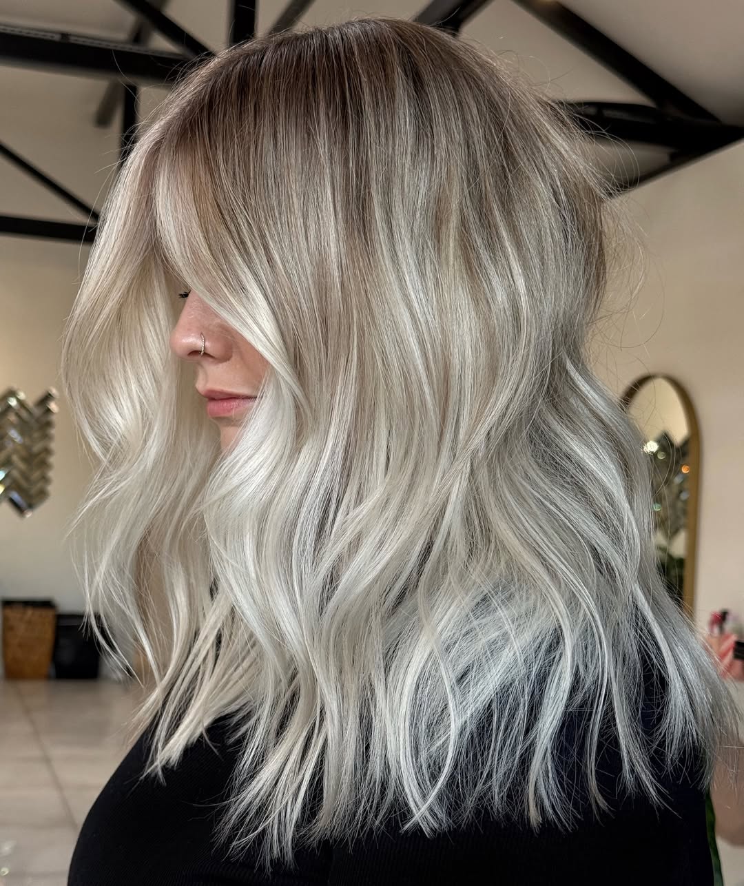 Close-up of a woman with vibrant summer babylights balayage 2026, featuring golden blonde highlights expertly blended into light brown hair. Perfect for a sunny, natural look.