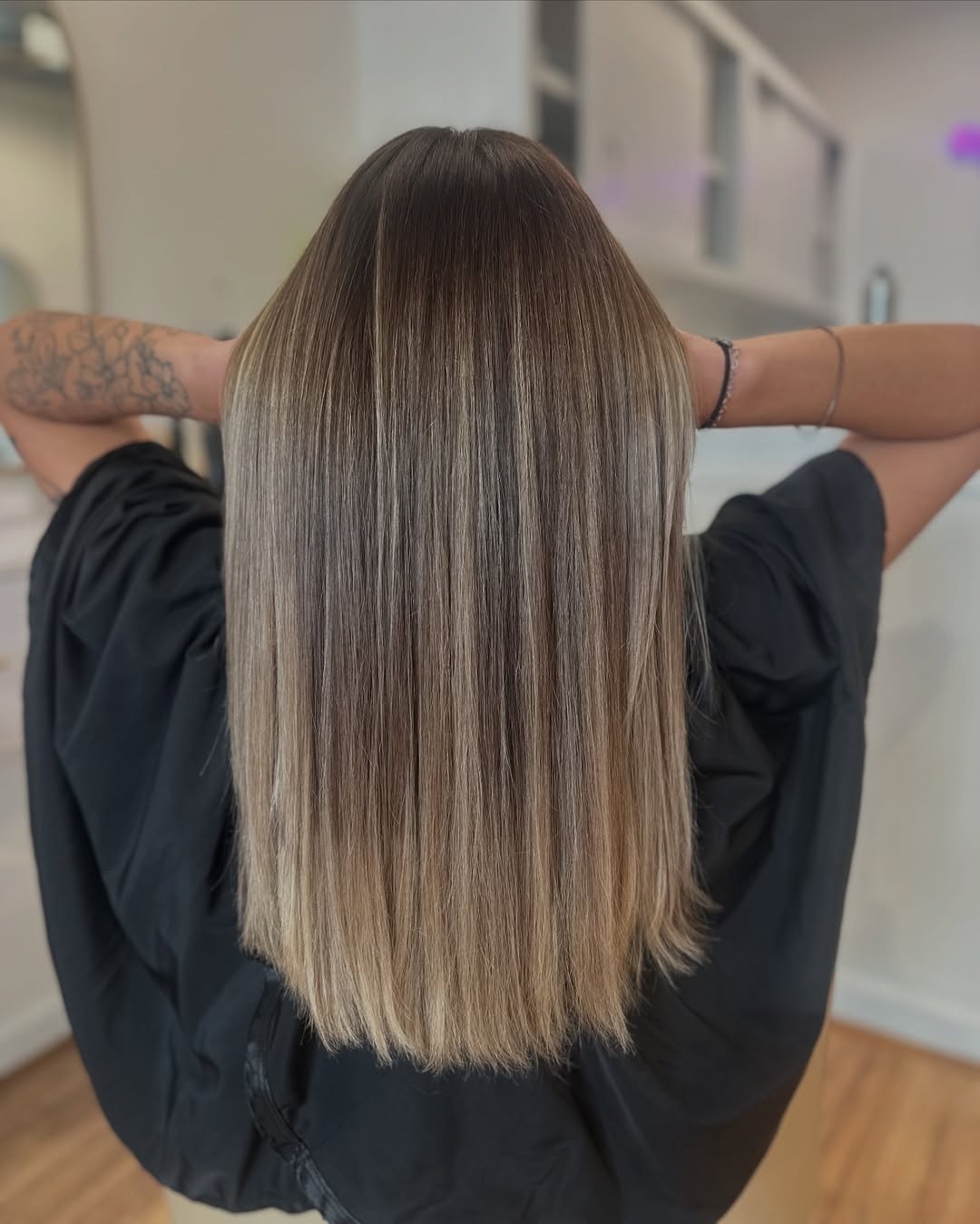 Close-up of a woman with vibrant copper red hair, showcasing one of the trendy summer hair color options for 2026. Her hair is styled in loose waves, complementing her warm skin tone for a sun-kissed look.