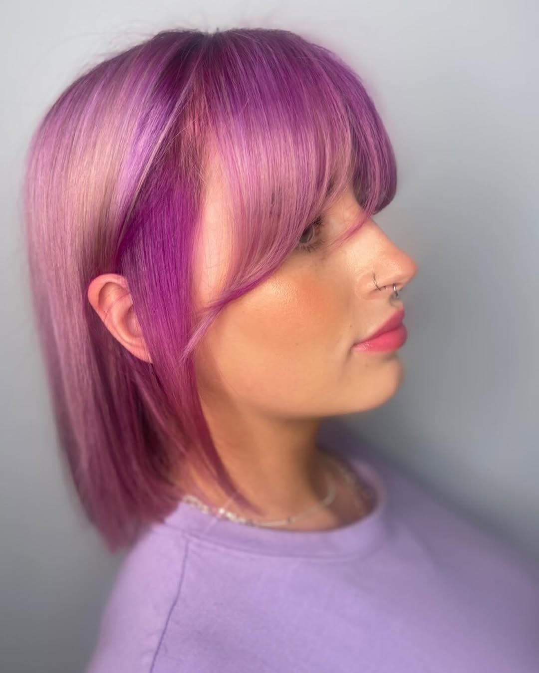 Close-up of a woman with vibrant copper-red hair, a trendy summer hair color option 2026, styled in soft waves.