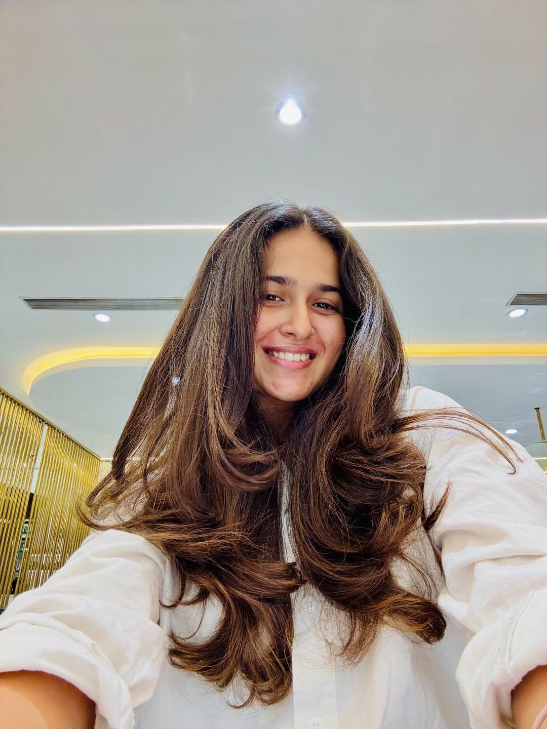 Close-up of a woman with a trendy shag haircut, perfect for summer haircuts inspiration 2026, featuring textured layers and bangs.