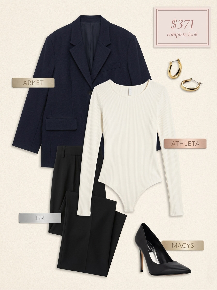 A professional 'Transitioning Office Edge' outfit, great for summer to fall transition outfits. It features a navy oversized blazer, a white V-neck bodysuit, and black wide-leg trousers. Black leather pumps and gold hoop earrings complete this polished business casual look for the office.