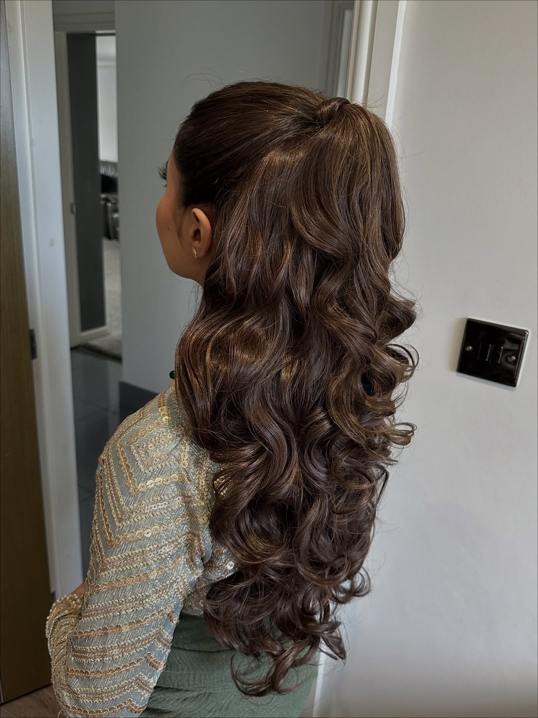 Blonde woman with a boho braided half-updo, showcasing a top summer hairstyle 2026, perfect for a casual outdoor event.