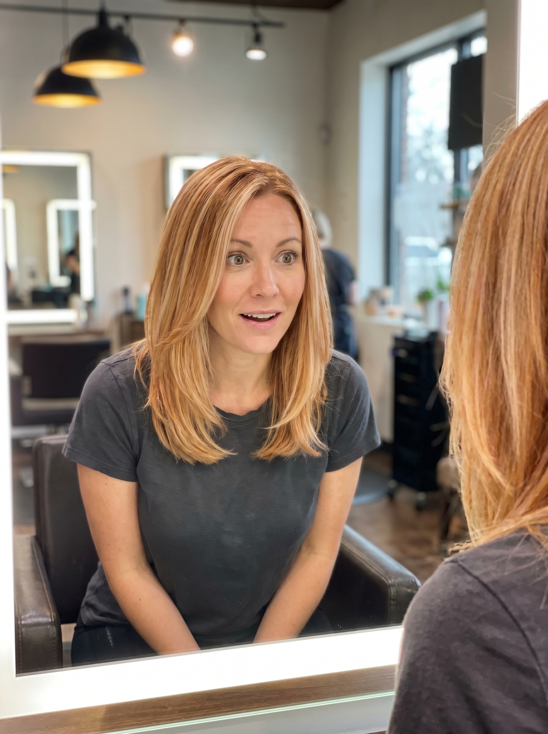 Soft, sun-kissed Apricot Blonde Ribbons on light warm blonde hair with apricot and honey tones, perfect for everyday or special occasions, enhanced with Kristin Ess gloss.