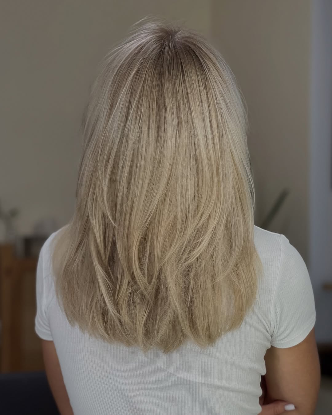 Close-up of a woman with a trendy, short blonde bob haircut for women haircuts summer 2026. The style is chic and modern, perfect for warm weather.