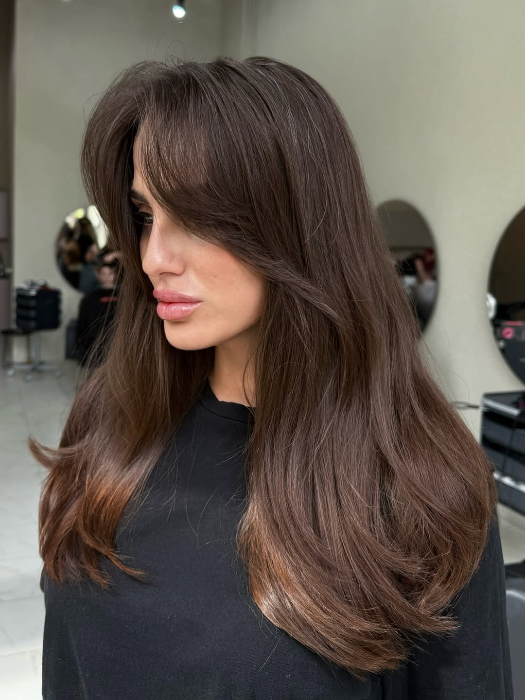 Beautiful woman with a chic, choppy bob haircut styled with loose waves, perfect for women haircuts summer 2026 trends. Her hair is a warm blonde, framing her face and highlighting subtle layers.