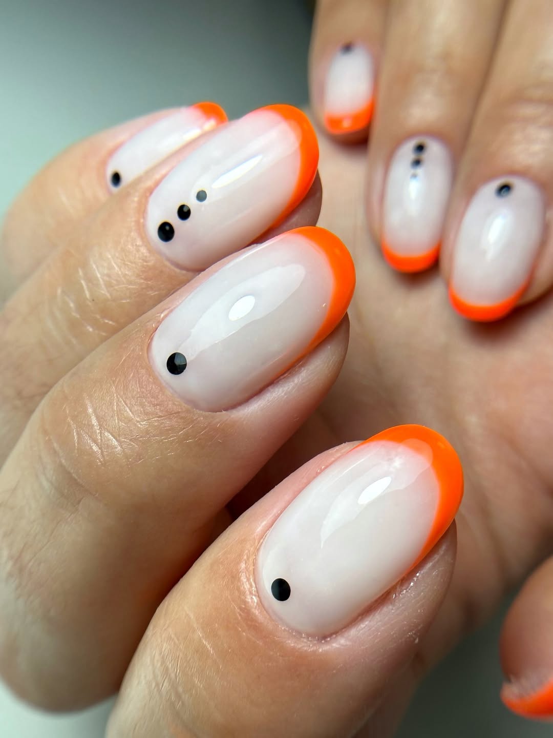Bright Orange Glossy French Tips With Minimal Dots