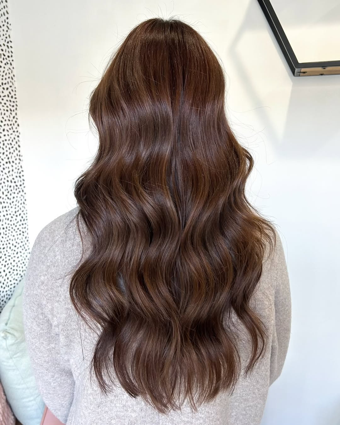 Chic Summer Days: Chocolate Brown Hair 2026 Style Woman with long, wavy chocolate brown hair smiling, wearing a light blue floral summer dress. Perfect for chocolate brown summer hair 2026 trends.