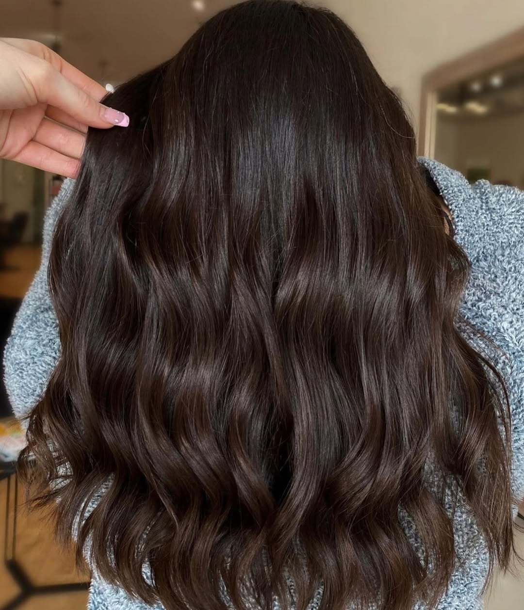 Chic Chocolate Brown Summer Hair 2026: Maxi Dress Style Woman with long, wavy chocolate brown summer hair 2026, styled in loose curls, wearing a vibrant turquoise flowing maxi dress, statement gold jewelry, and sandals, enjoying a sunny outdoor picnic.