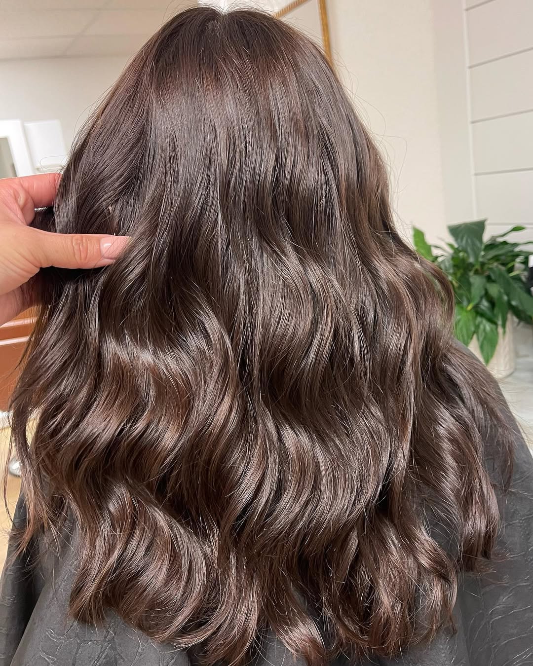 Chic Summer Flow: Chocolate Brown Hair & Sundress 2026 Woman with long, wavy chocolate brown summer hair 2026, wearing a flowy white sundress, smiling outdoors in natural light for a casual look.