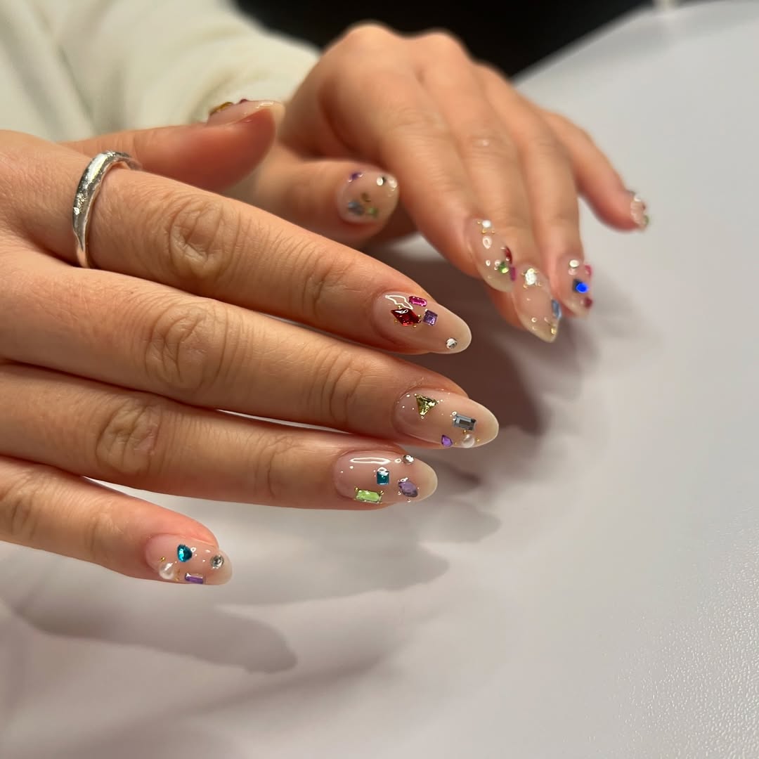 Clear Nude Glossy Oval Nails with Rhinestone Embellishments