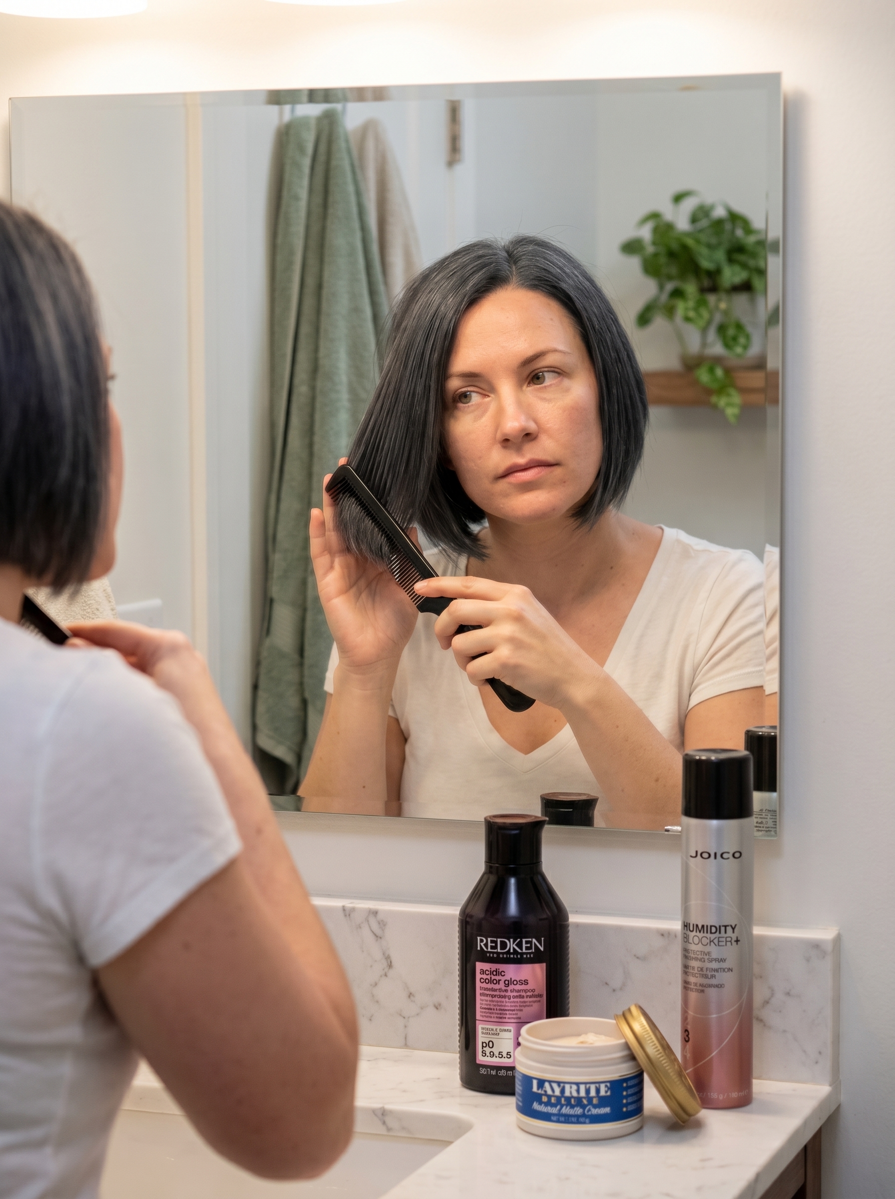 Sophisticated Asymmetrical Ink Bob: Edgy Dark Hair Summer 2026 A sharp asymmetrical ink bob, a sophisticated edgy dark hair summer 2026 look in matte charcoal and jet black. Styled with matte finishing cream and a fine-tooth comb for work or date night.