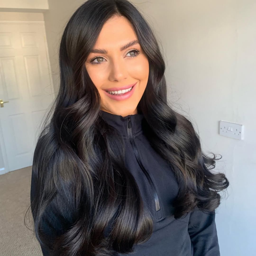 Edgy Dark Hair Summer 2026: Street Style Vibes Woman with edgy dark hair wearing a black mesh top, denim shorts, and combat boots. Perfect for edgy dark hair summer 2026 street style.
