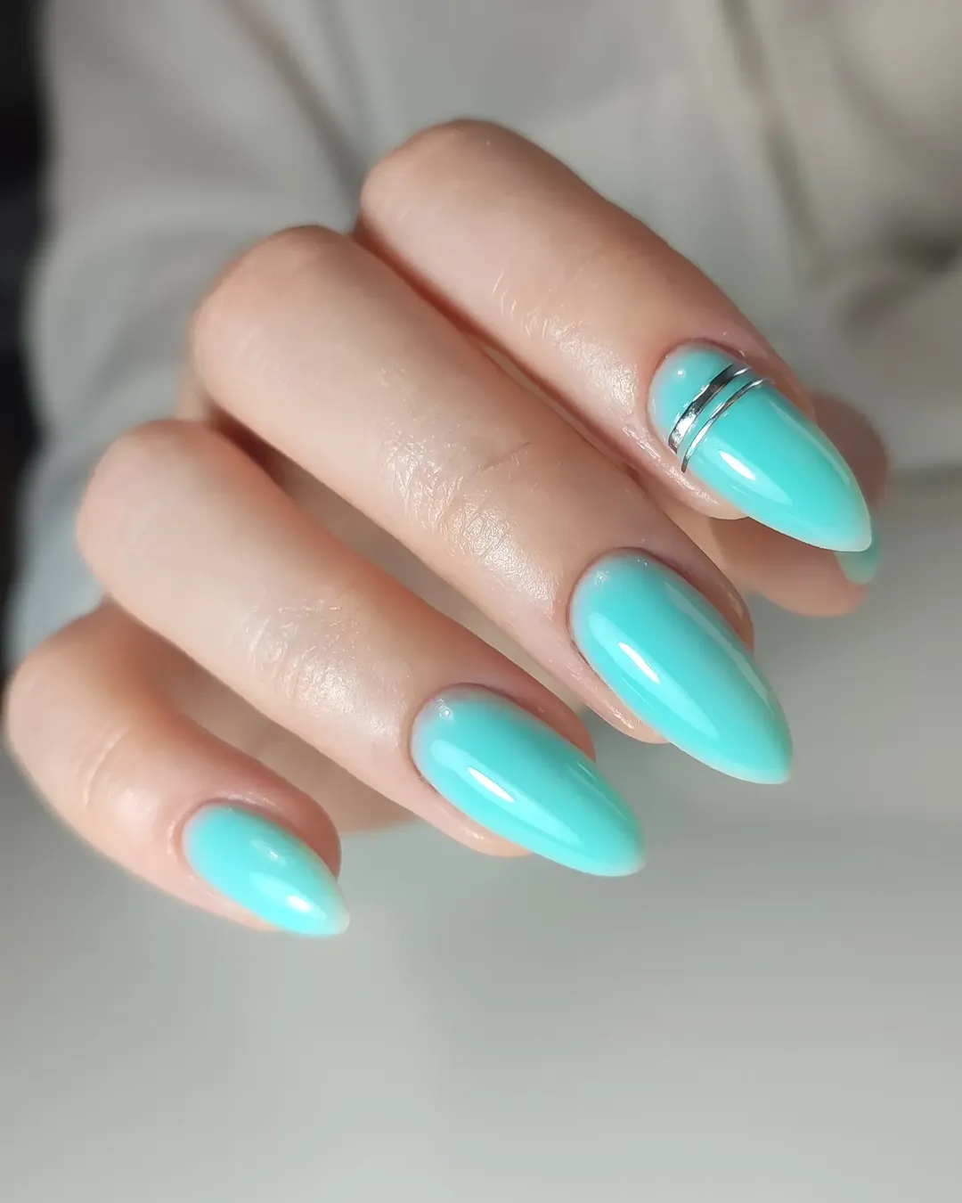 Glossy Aqua Almond Nails With Accent Ring