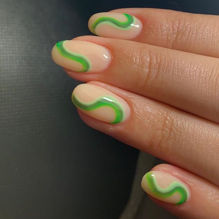 Glossy Nude With Vibrant Green Swirl Nail Art