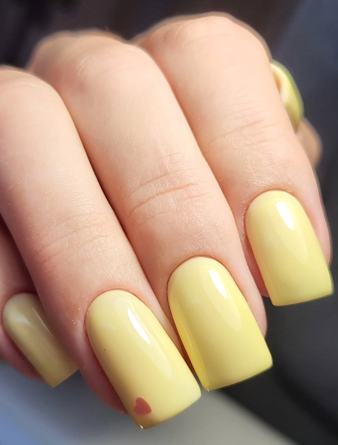 Glossy Pastel Yellow Squoval Nails With Tiny Heart