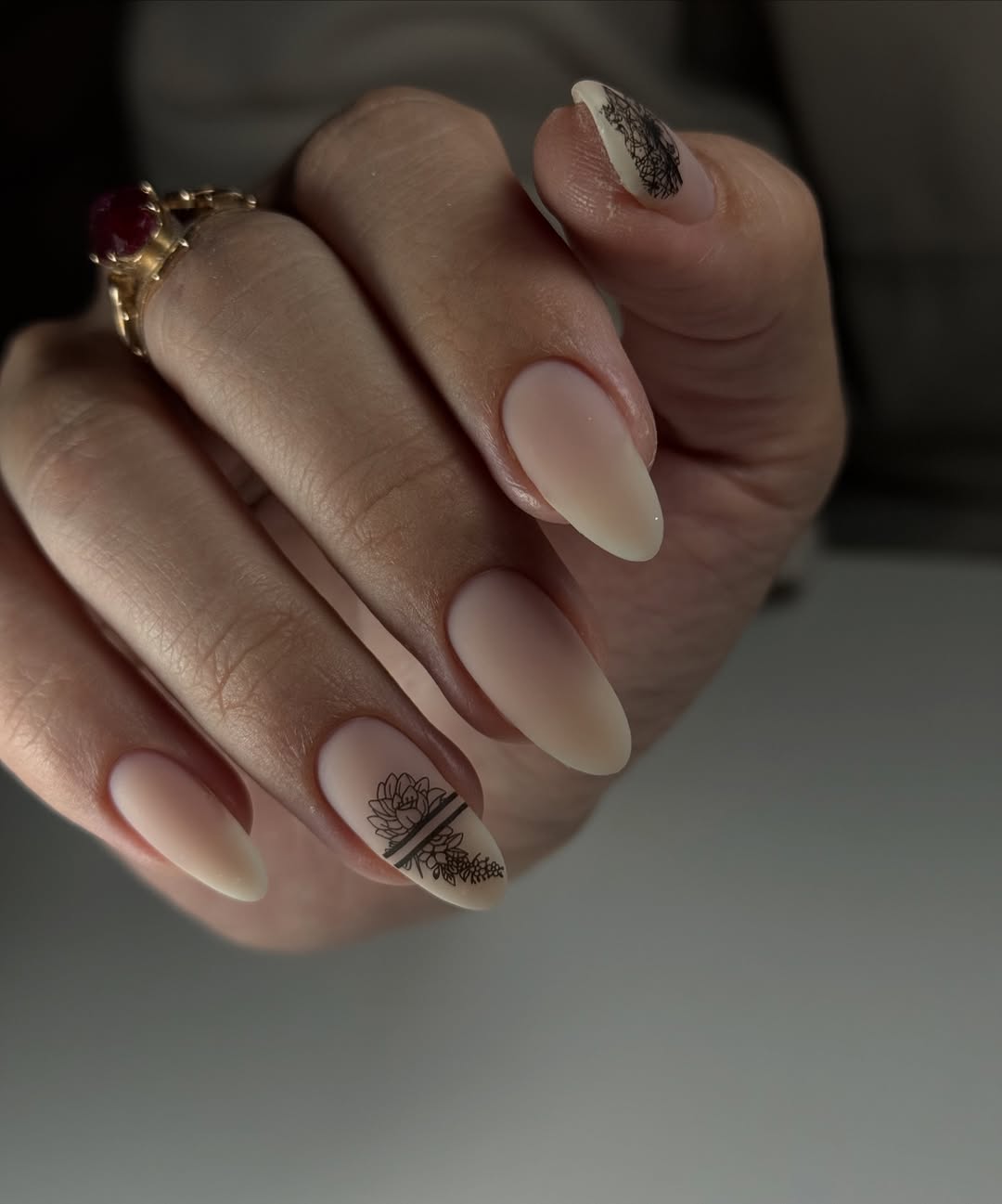 Matte Nude Almond Nails With Delicate Black Floral Art