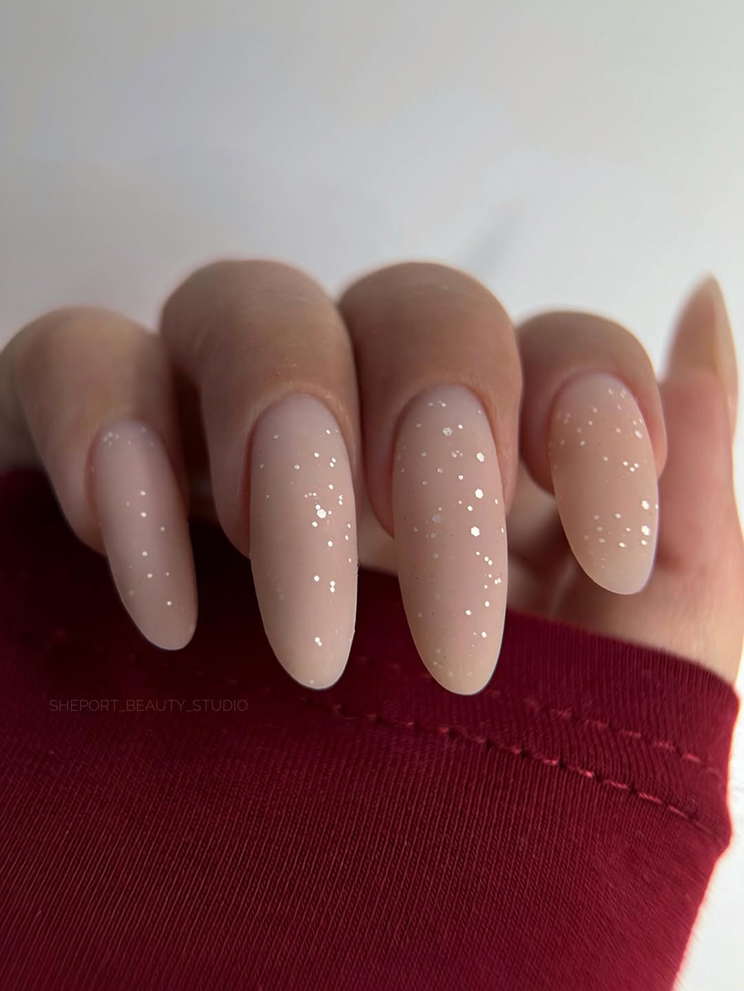 Matte Nude Almond Nails With Glitter Flakes