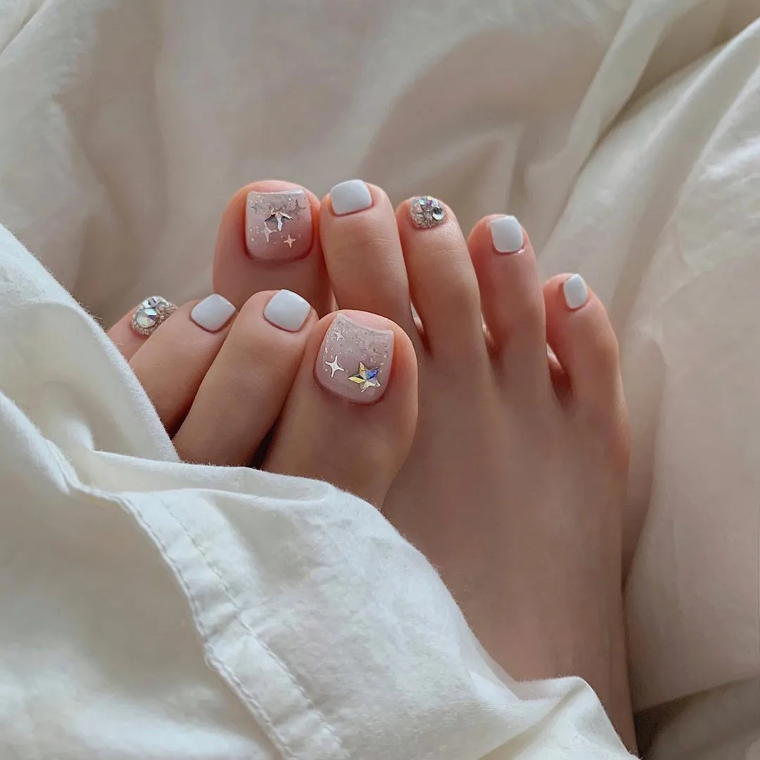 Milky White Pedicure With Star Glitter Accents