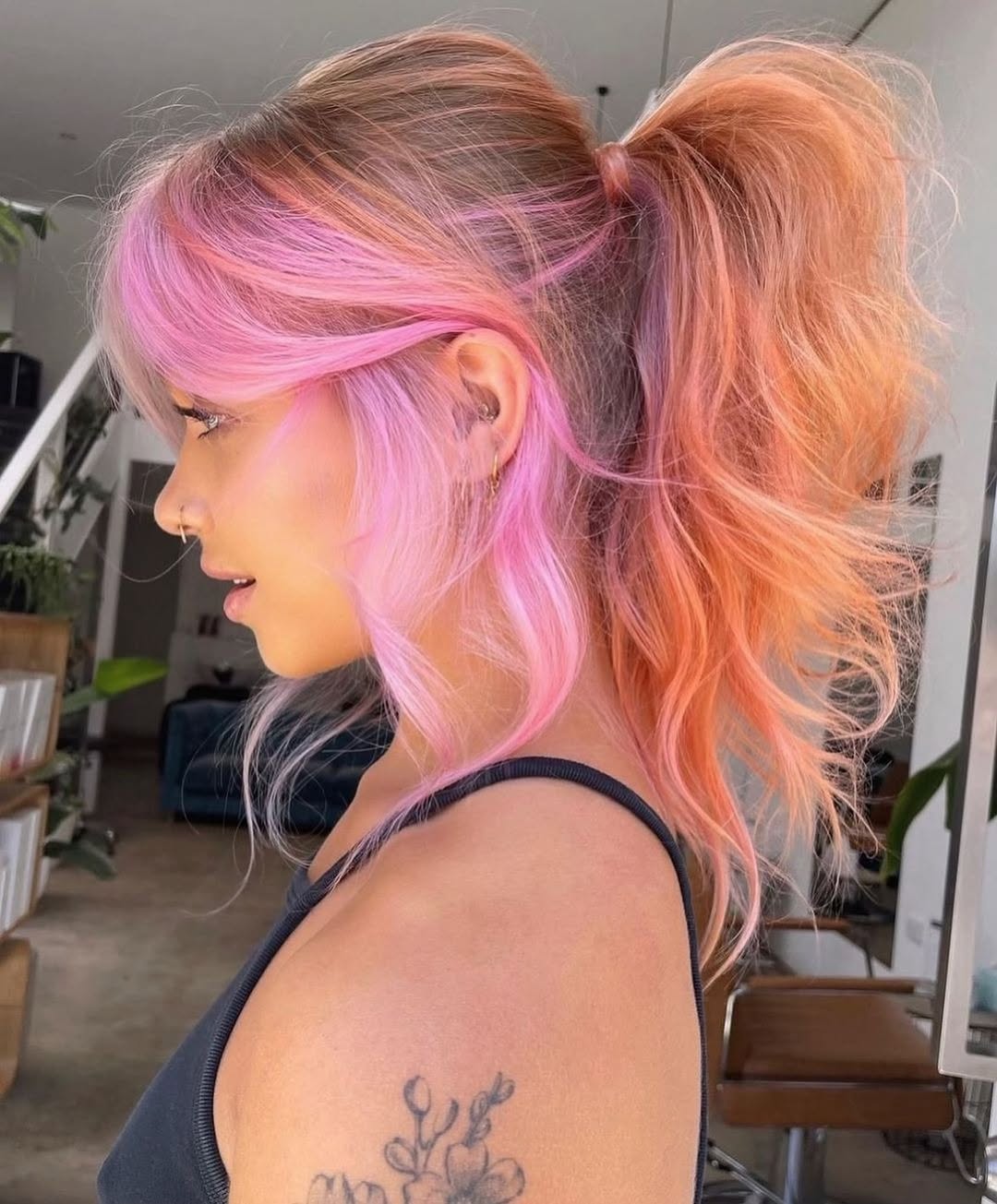 Close-up of a woman with vibrant pastel hair color summer 2026, styled in soft waves, complemented by natural makeup. The focus is on the multi-toned, dreamy pastel hues.