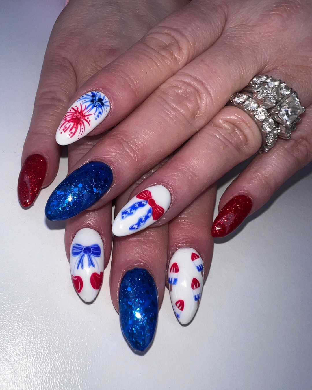 Patriotic Glitter Almond Nails with Hand-Painted Motifs