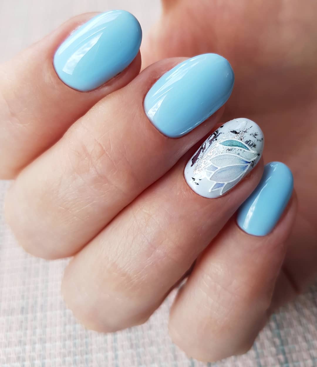 Sky Blue Oval Nails With Delicate Floral Accent