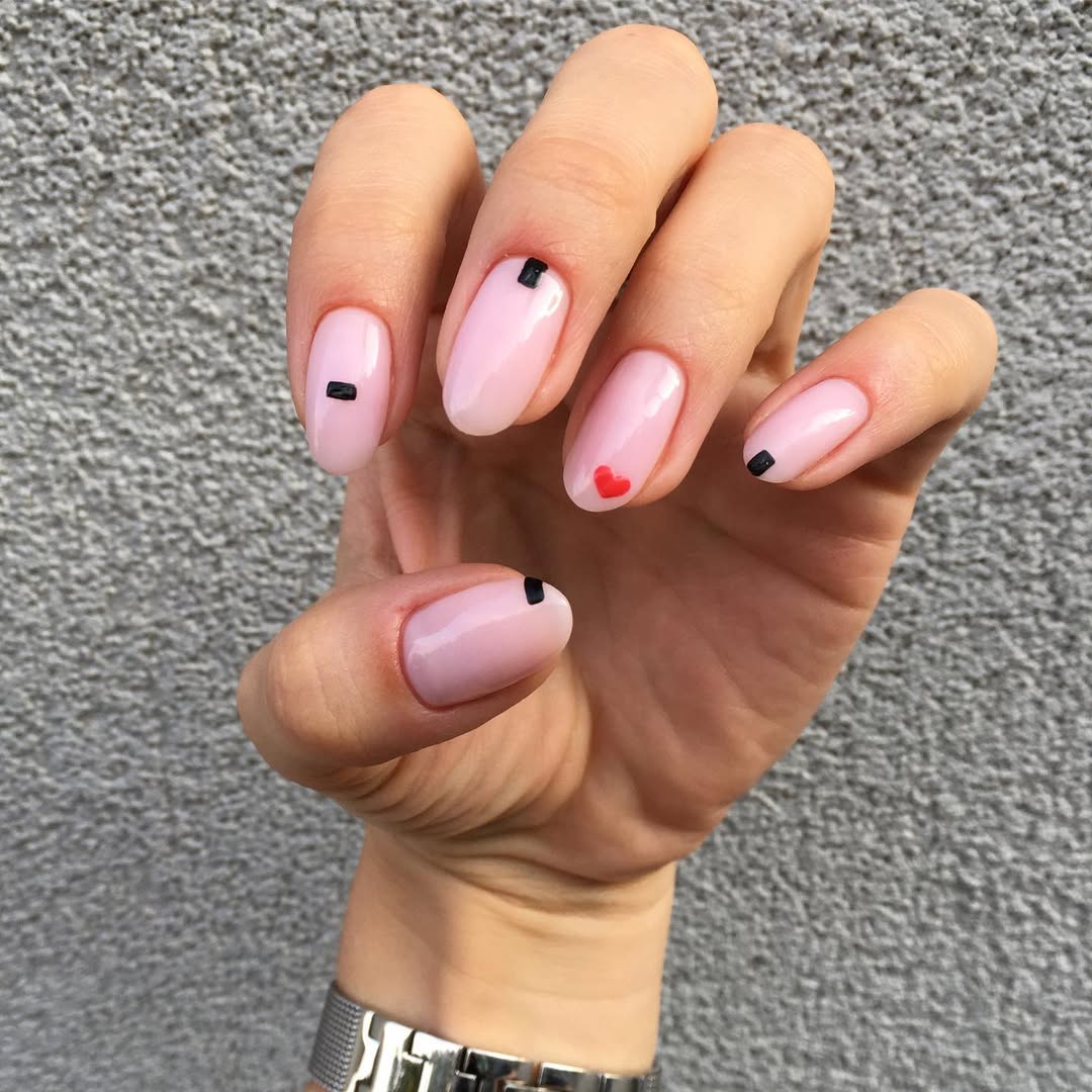 Soft Pink Oval Nails with Minimalist Black and Red Art