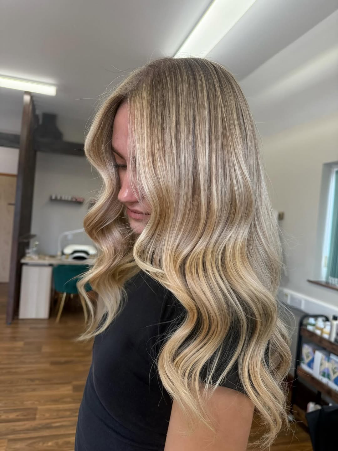 Close-up of a woman with cool-toned, ash blonde hair, demonstrating a perfect soft summer palette hair color for 2026.