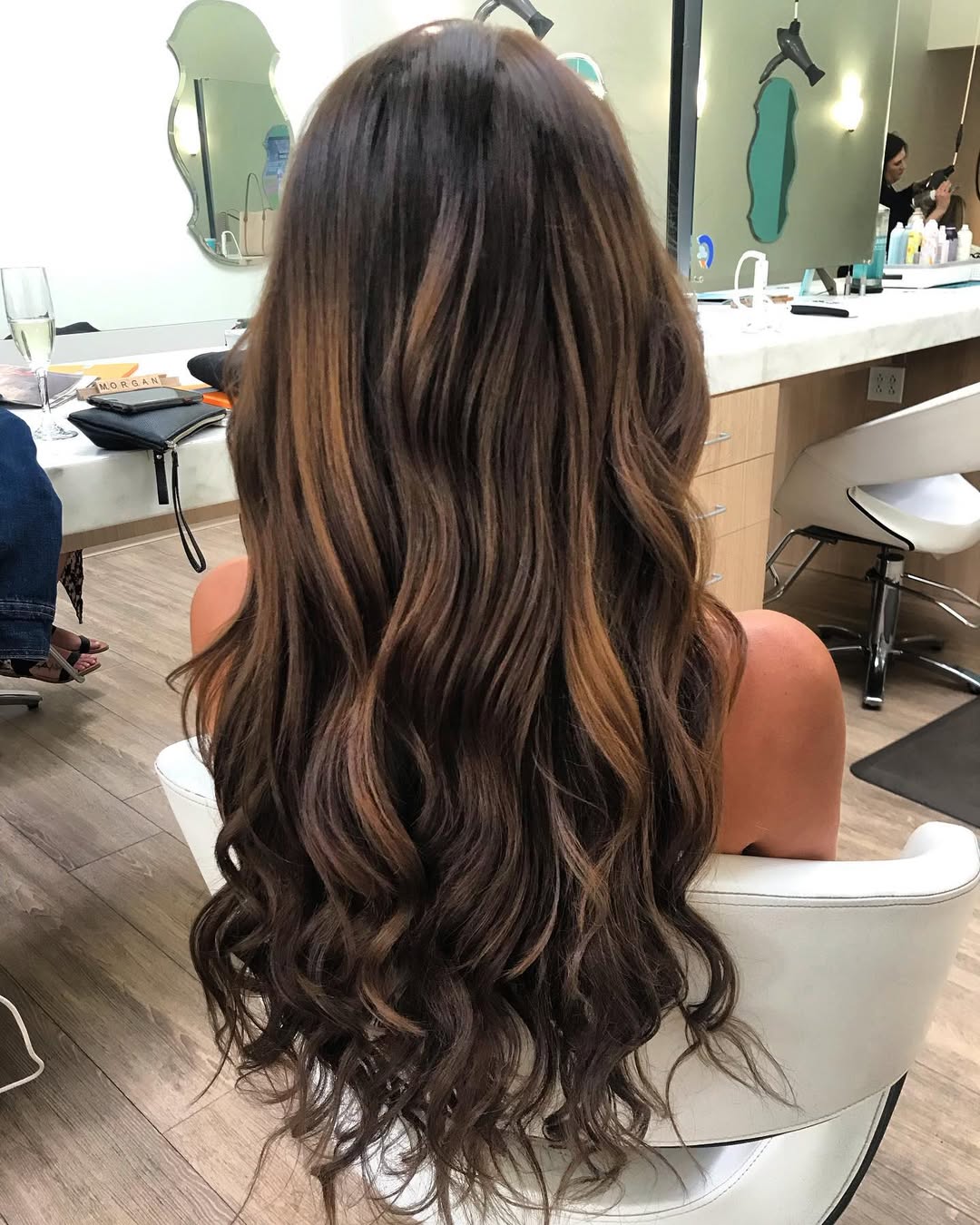 Stunning Summer Beachy Waves Hair 2026 Close-up of a woman with golden blonde summer beachy waves hair 2026, styled loosely with natural texture for a casual look. She's outdoors enjoying the sun.