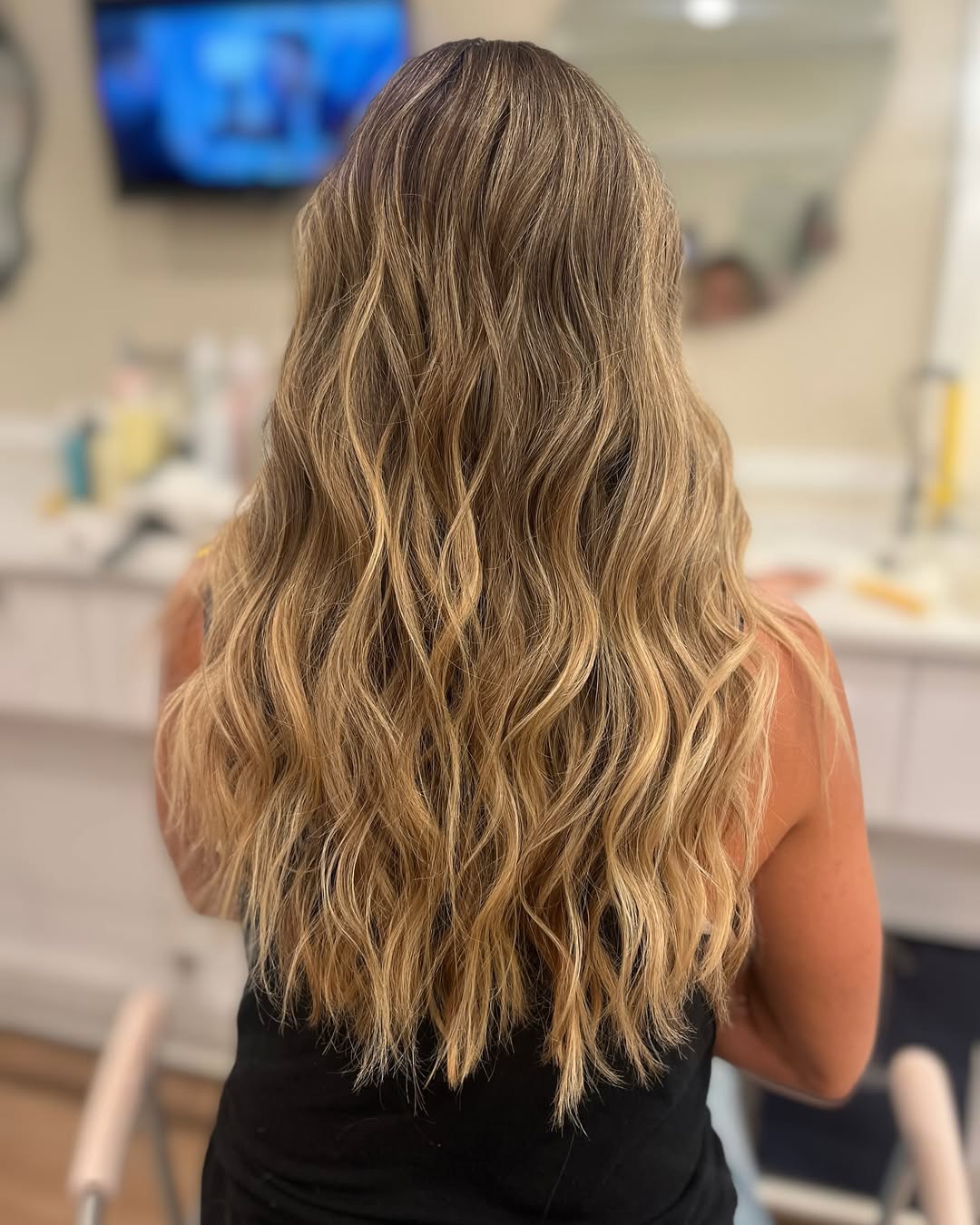 Stunning Summer Beachy Waves Hair 2026: Effortless Charm Close-up of a woman with beautiful, natural-looking summer beachy waves hair 2026, styled casually for a outdoor summer day. Her hair is light brown with subtle highlights.
