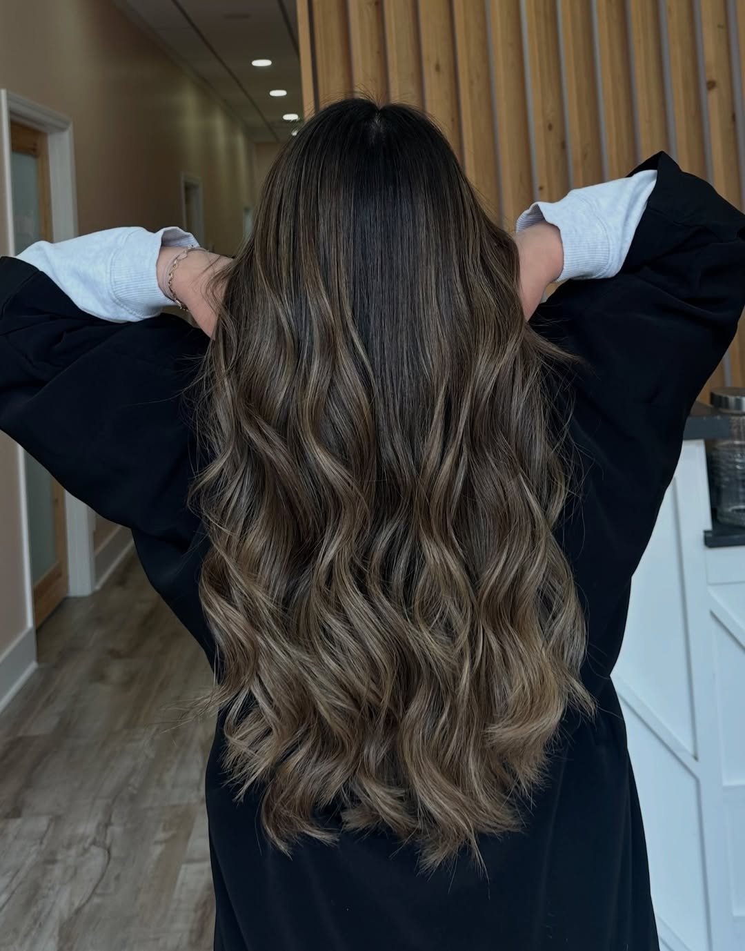 Close-up of a woman with vibrant copper balayage, a cute summer hair color idea for fair skin, styled in soft waves.