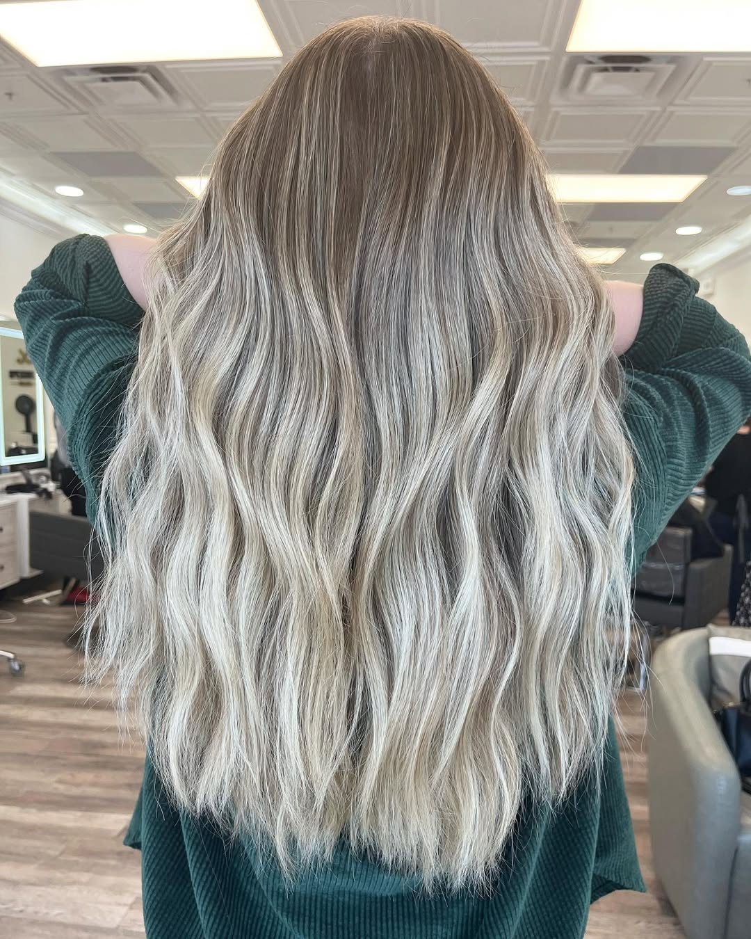 Close-up of a woman with vibrant copper balayage, a cute summer hair color idea for 2026, styled in soft waves.