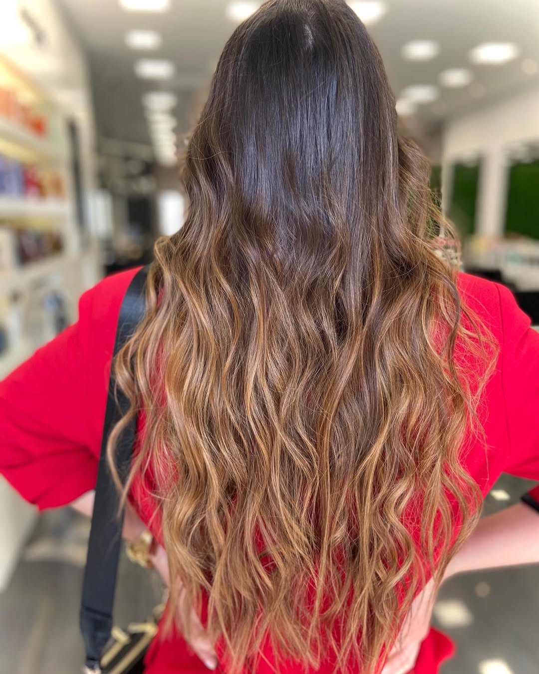 Close-up of a woman with vibrant golden blonde, sun-kissed ombre hair, styled with loose waves, showcasing a perfect summer hair color cute idea for 2026.