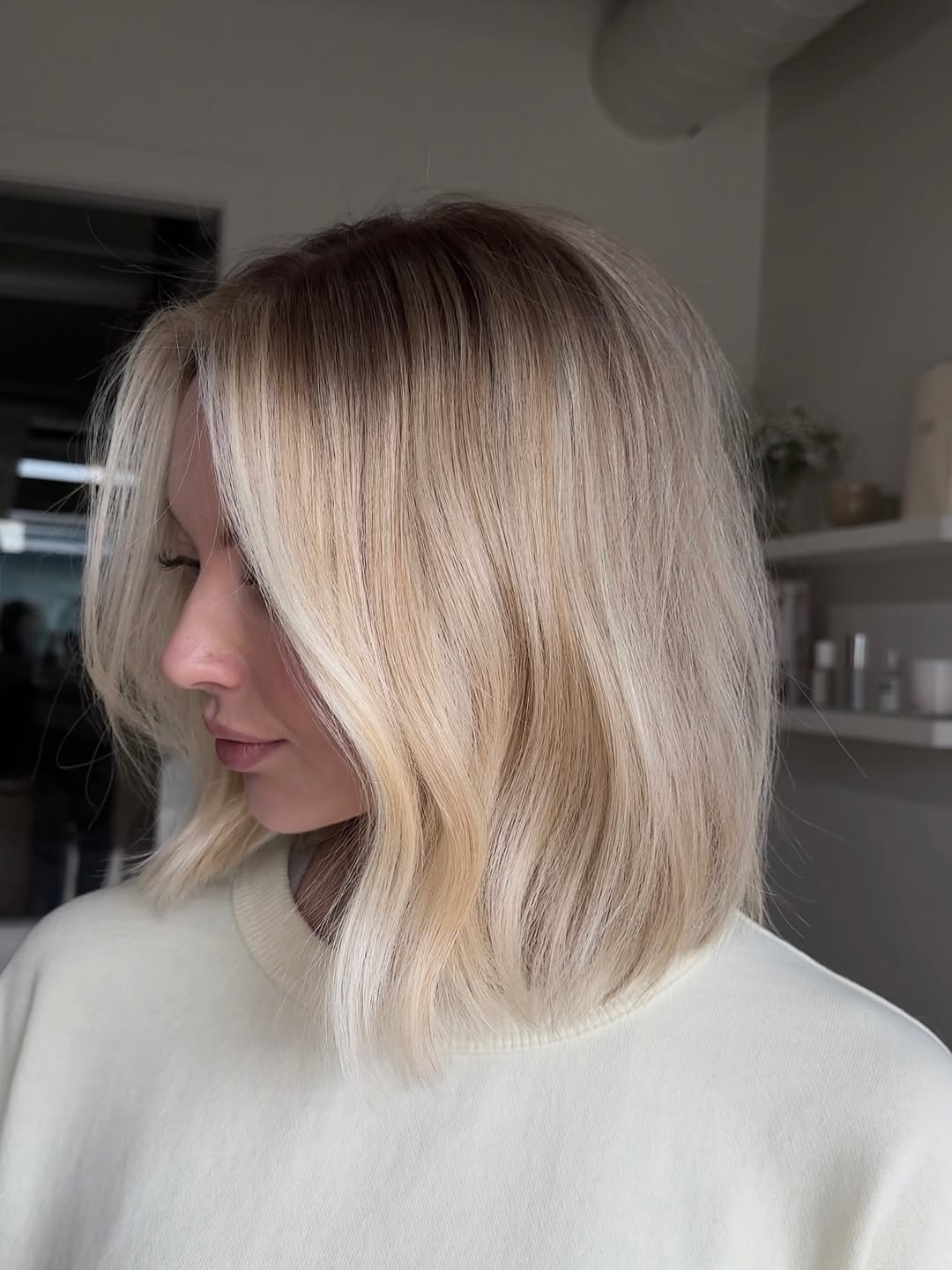 Close-up of a woman with vibrant copper balayage highlighting her long, wavy hair, perfect for summer hair color cute ideas. This warm, sun-kissed look brightens her complexion for casual wear.