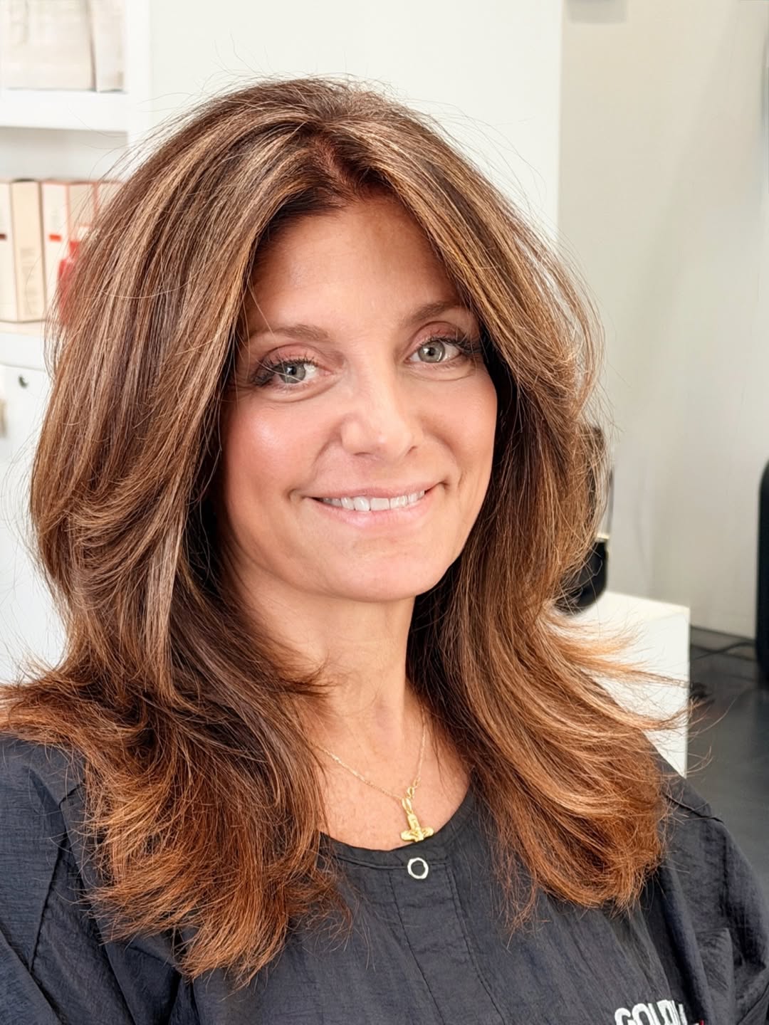 A woman with long, sun-kissed blonde hair styled in loose beach waves, perfect for summer hair ideas women looking for effortless chic.