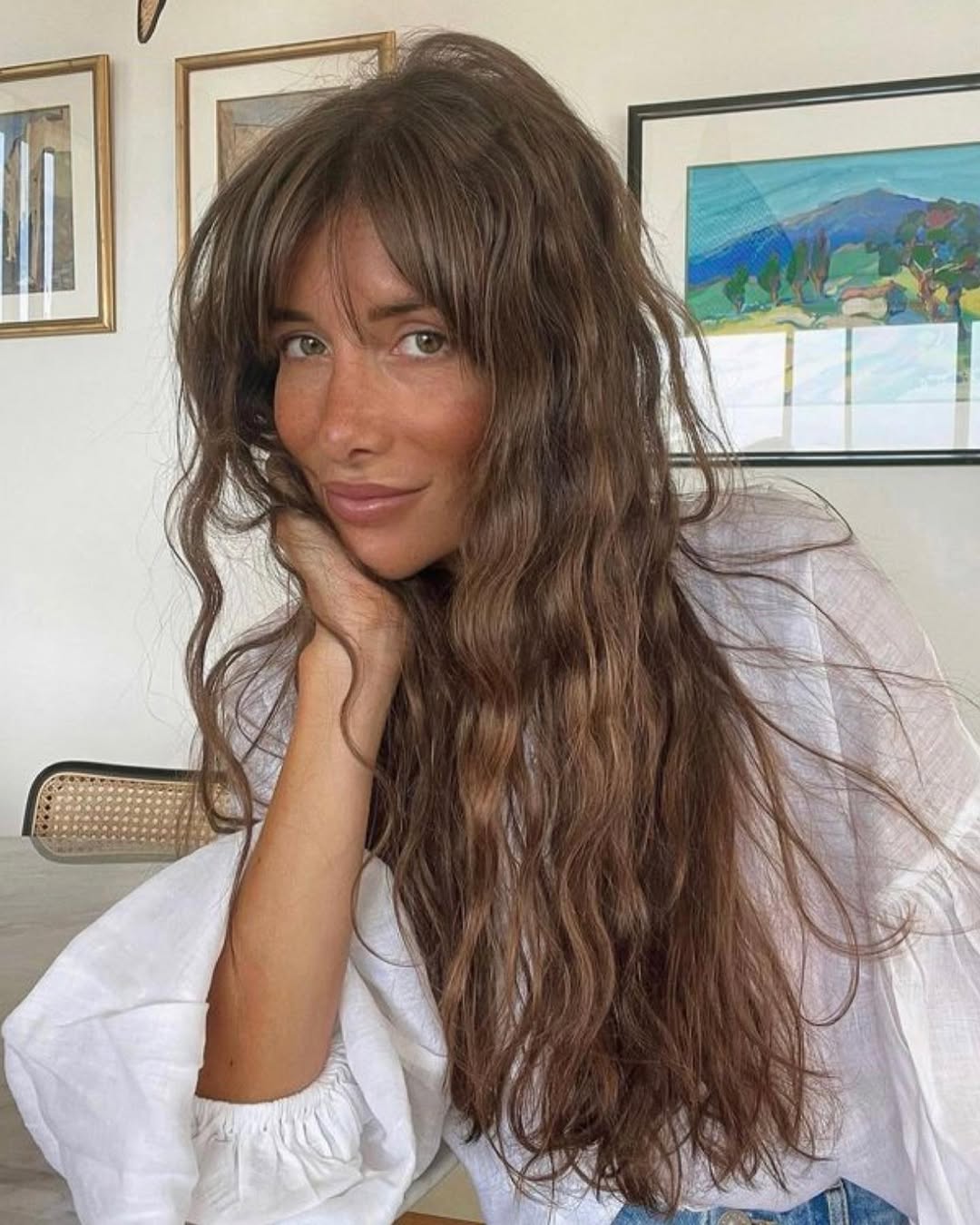 Close-up of a woman with braided summer hair ideas, showcasing a chic, sun-kissed style perfect for casual outings or beach days. Her hair is a bright blonde with intricate braids framing her face.