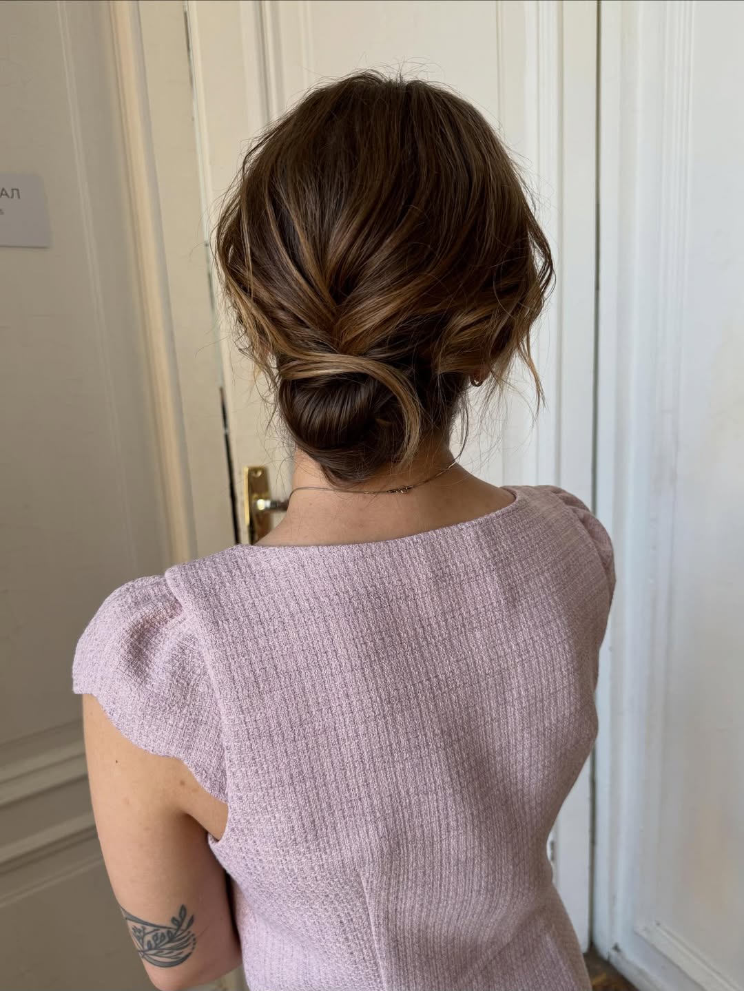 A woman with long, shiny dark hair styled in soft, romantic waves, perfect for summer hairstyles long hair ideas 2026. She is smiling softly, showcasing beachy waves with a side part, creating a glamorous yet effortless look.