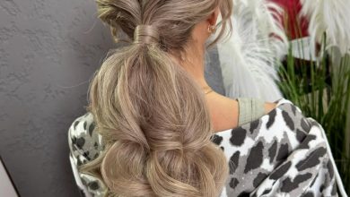 Beautiful woman with long, shiny brown hair styled in a flowing, loose bohemian braid accented with delicate flowers, perfect for summer hairstyles long hair ideas 2026.