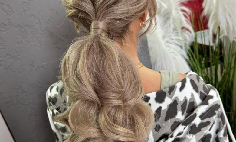 Beautiful woman with long, shiny brown hair styled in a flowing, loose bohemian braid accented with delicate flowers, perfect for summer hairstyles long hair ideas 2026.