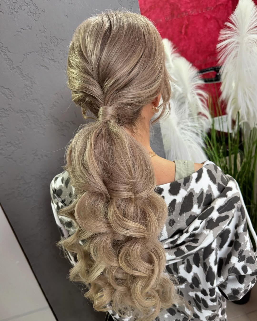 Beautiful woman with long, shiny brown hair styled in a flowing, loose bohemian braid accented with delicate flowers, perfect for summer hairstyles long hair ideas 2026.