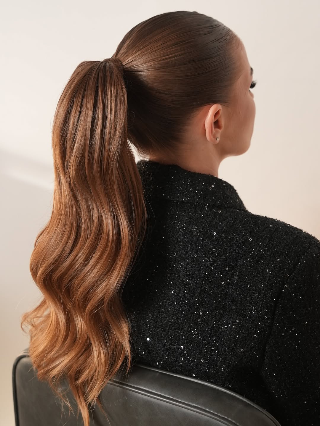 Woman with elegant half-up twisted braid, perfect for summer hairstyles long hair ideas 2026 for a garden party or wedding.