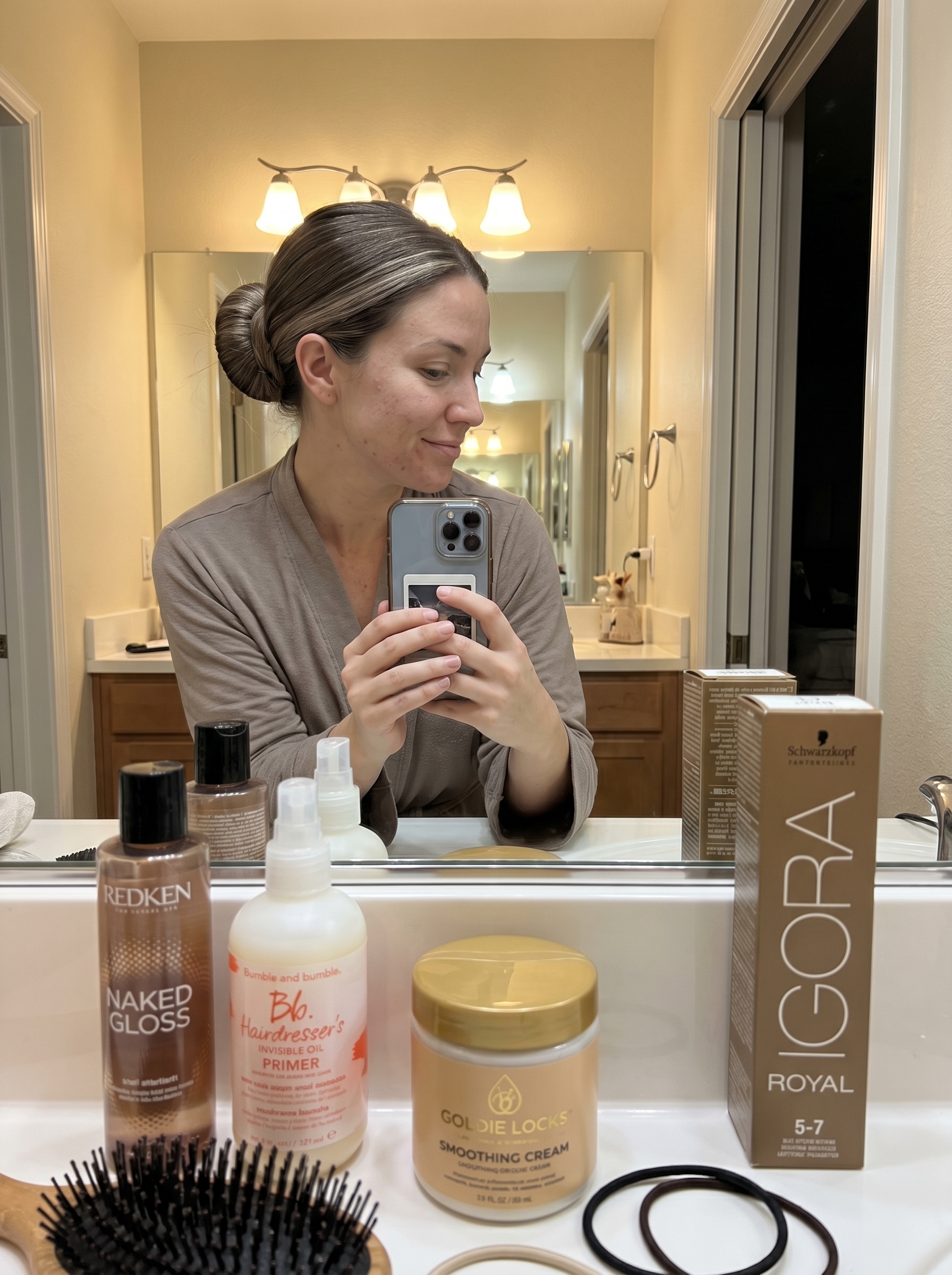 Sophisticated Desert Minimalist Sleek Bun with Mushroom Bronde color, a polished summer hairstyle for long hair ideas 2026. This minimalist look in earthy brown with cool beige tones suits work, formal events, or everyday. Features anti-frizz cream and lightweight finishing oil.