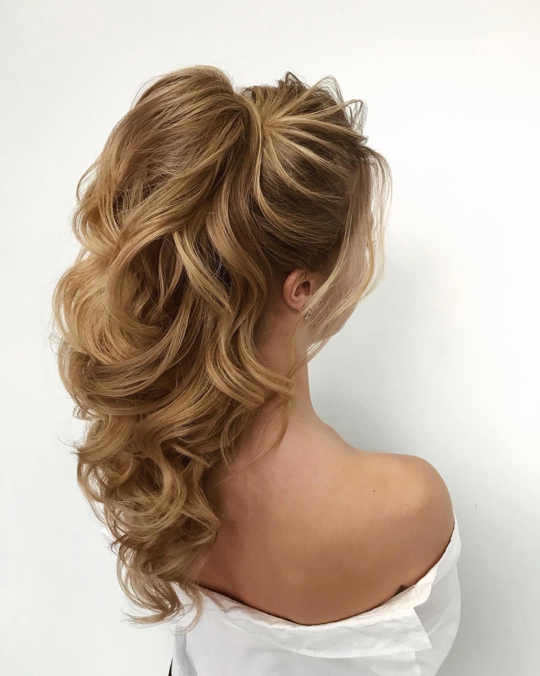Beautiful woman with long, flowing brown hair styled in soft, natural waves. This is a gorgeous summer hairstyle long hair idea, perfect for a casual yet elegant look.