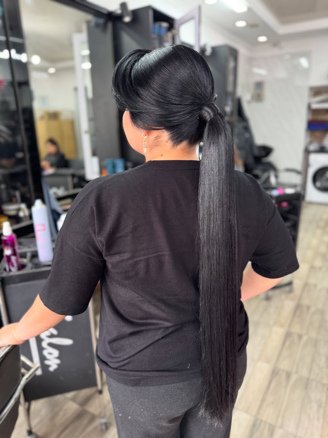 Beautiful woman with long, shiny brown hair styled in soft, cascading waves, perfect for summer hairstyles long hair ideas 2026. Her hair frames her face, enhancing her natural beauty.
