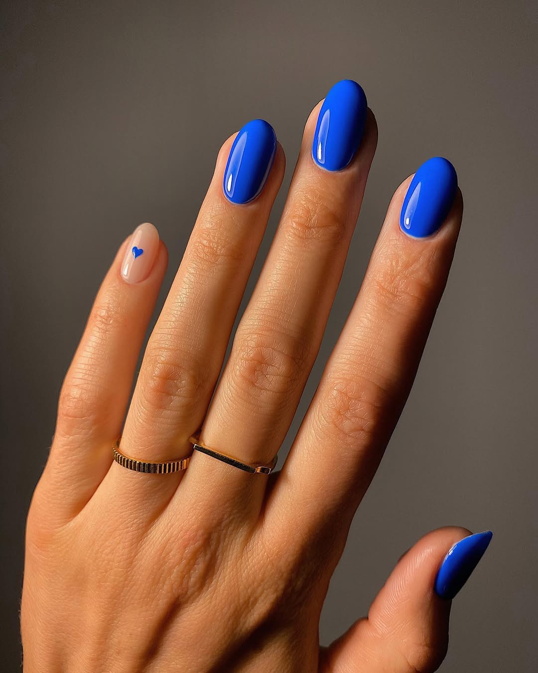 Vibrant Cobalt Blue Glossy Oval Nails with Accent Heart