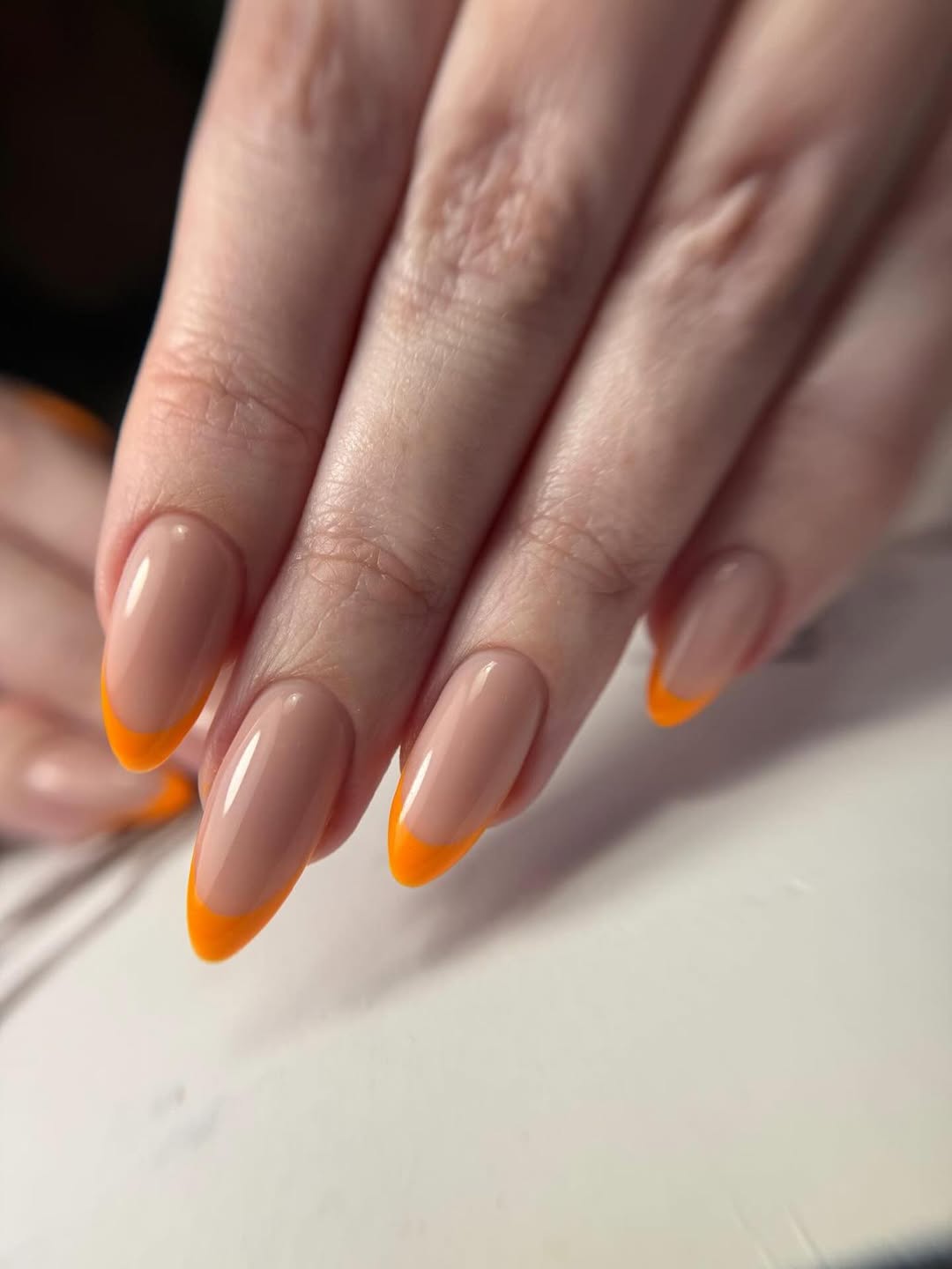 Vibrant Orange French Tip Almond Nails