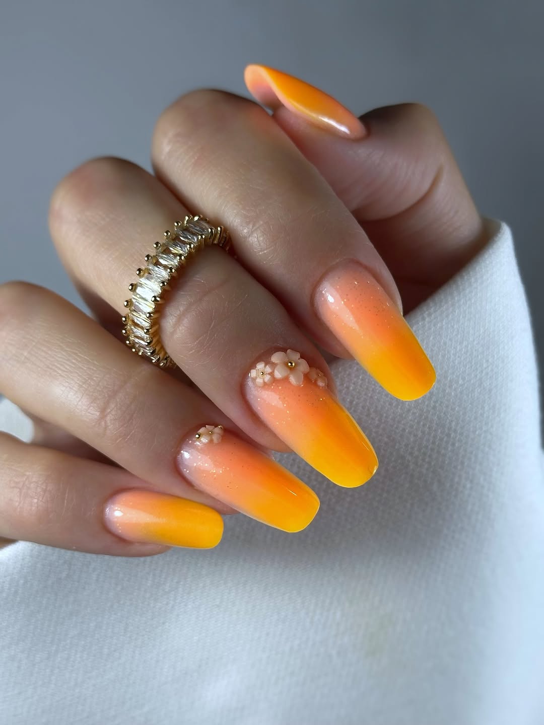Vibrant Orange Gradient Coffin Nails With Floral Accents